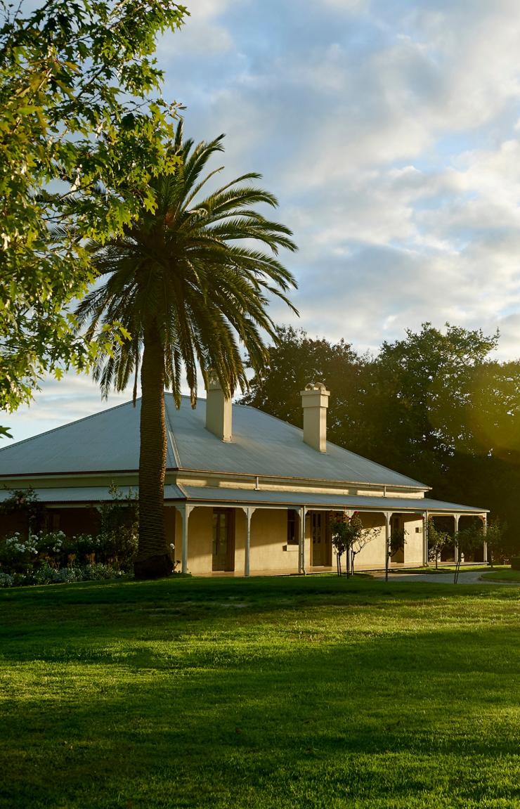 A side on view of The Chandon Homestead and the expansive lawn, Yarra Valley, Victoria © Chandon Homestead / Earl Carter Photography